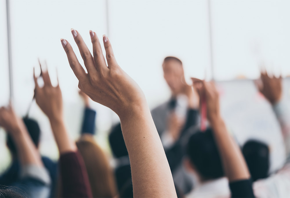 Hands raised at presentation