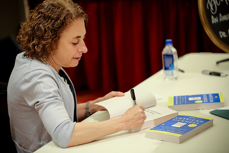 Elisabeth Rosenthal signing a book
